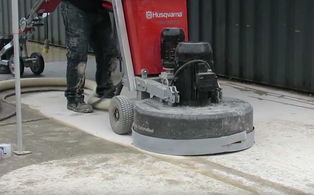 Winnipeg warehouse flooring installers grinding concrete to smooth finish.